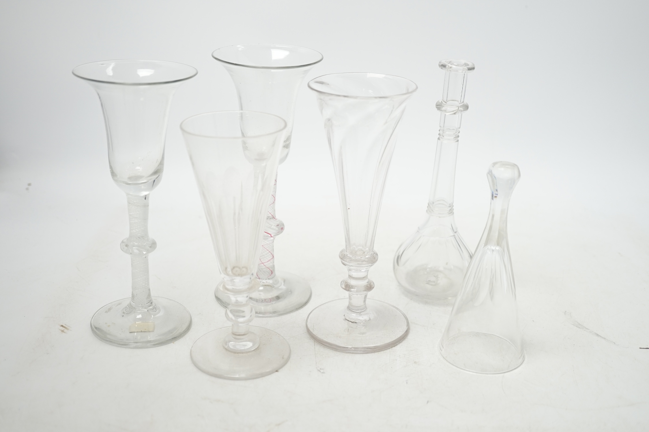 Two 18th century Dutch wine glasses, colour twist and opaque twist stems, two ale glasses, a toddy lifter and a stirrup cup, tallest 16.5cm. Condition - good